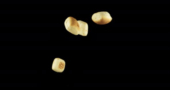 Sweet Italian bread flying against black background