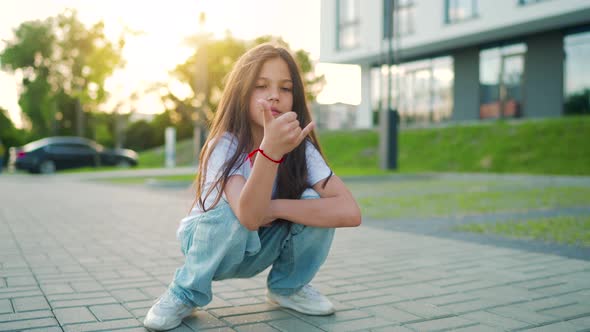 Portrait of Positive Girl with Long Hair Looking at Camera an Sunset