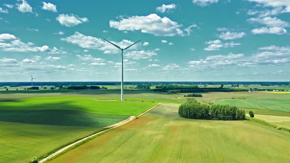 Wind turbines on green field in summer, Poland