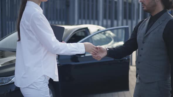 Side View Unrecognizable Woman and Man Shaking Hands in Slow Motion and Businessman Leaving to Car