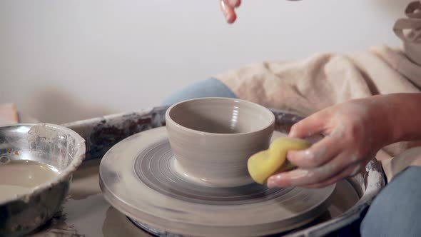 Sculpter Making Clay Vase in Studio.