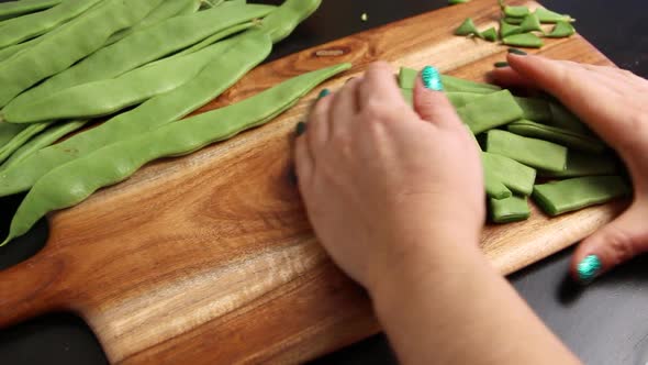 Woman's hands take away piattoni green beans close up