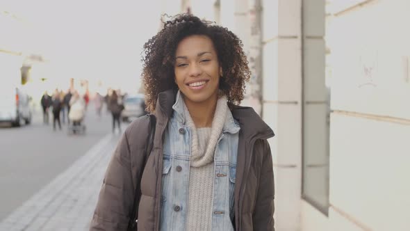 Portrait of Young Beautiful Mixed Race Woman with Afro Haircut Walking