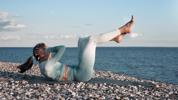 Athletic Woman Training Abs on Sunrise Sunset Beach Practicing Morning Outdoor Workout Slowmo