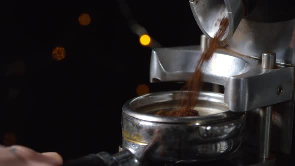 Barista Filling Portafilter with Freshly Ground Coffee
