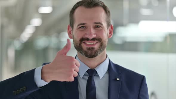Portrait of Positive Businessman Doing Thumbs Up