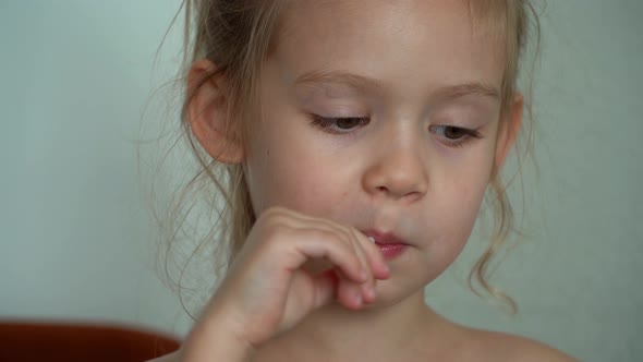 Close Up of Little Girl Sucks Sweet Fruit Lollipop
