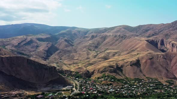 Aerial Drone Zoom in of Mountains and Houses in Armenia