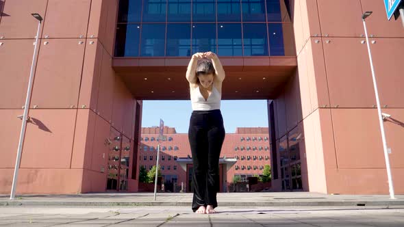 Woman bending forward in city