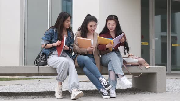 three asian girl students talking at break time sitting on campus