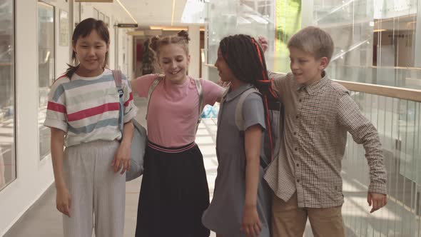 School Children Throwing Paper Airplanes at Camera and Hugging