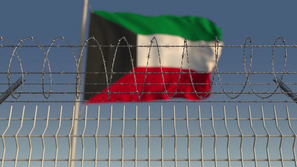 Barbed Wire Against Waving Flag of Kuwait