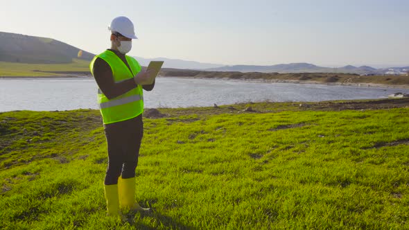 Engineer working in farmland and lake.