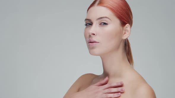 Studio portrait of young, beautiful and natural redhead woman. Beauty concept.