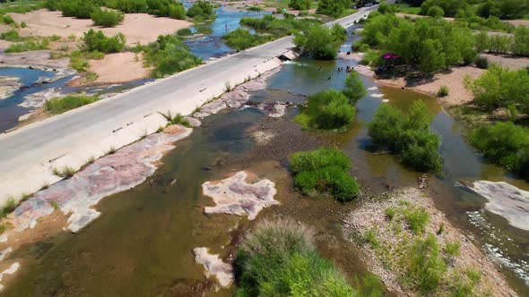 Aerial footage of the popular area on the Llano River in Texas called The Slab. Camera is moving fas