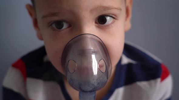 Close-up child breathing with a nebulizer
