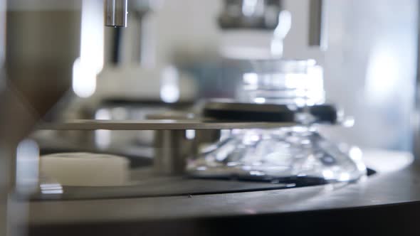 Automated pharmaceutical manufacturing line, bottles filled with liquid