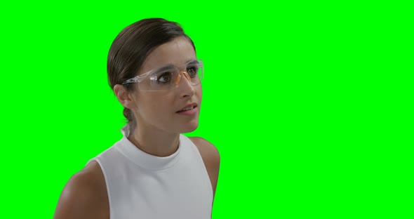 Businesswoman wearing futuristic eyewear while using digital screen