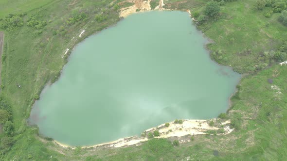 Turquoise colors of abandoned quary with fresh water 4K drone video