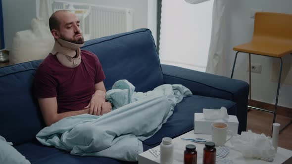 Injured Man Wearing Cervical Neck Collar Against Muscle Pain