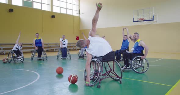 Persons with Disabilities Stretching Before a Basketball Game in the Modern Hall