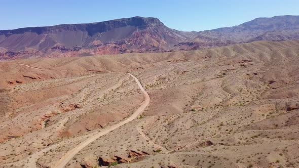 Aerial drone view overlooking sand road in Kingman wash, sunny day in Arizona, USA