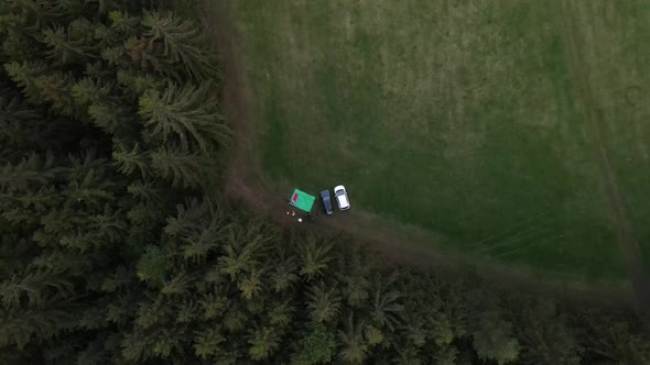 People camping next to the forest with fire. Aerial 4k drone view.