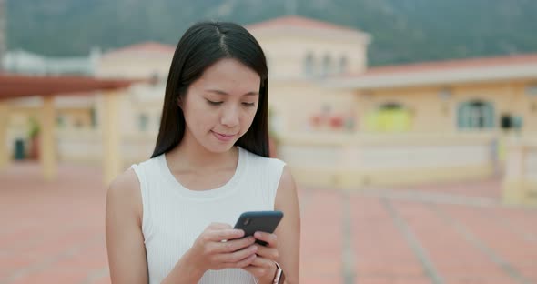 Woman use of mobile phone in city