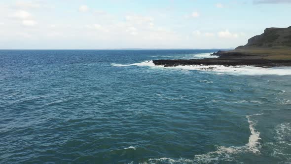 Aerial view of rocky coastline and waves