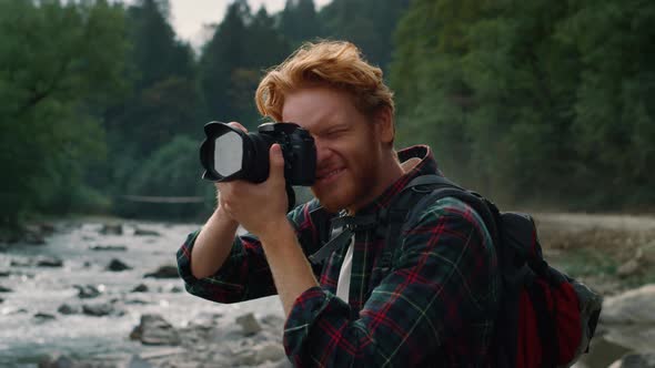 Hiker Shooting Landscape in Mountains