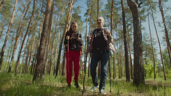 Middle Aged Hiker Man with Backpack Cheering Up Tired Woman on Trek