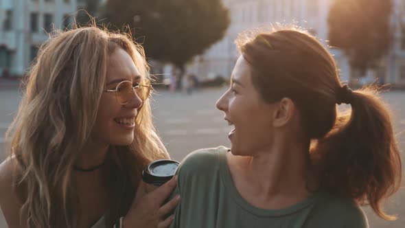 Two Best Friends Meet Together Outdoors at Beautiful Summer Day in Golden Sunset Hour. Unexpected