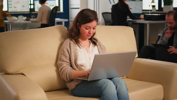 Manager Woman Searching on Laptop Sitting in Relax Zone on Confortable Couch