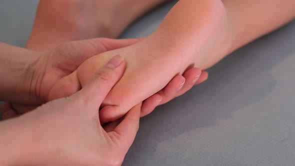 Mother is Doing Massage on Her Baby Foot