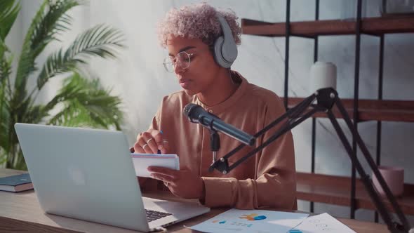 Young Millennial Woman Sitting at Desk and Leads Her Live Broadcasting Online