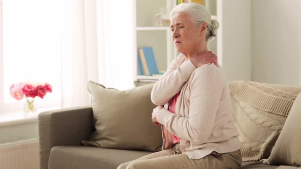 Senior Woman Suffering From Neck Pain at Home