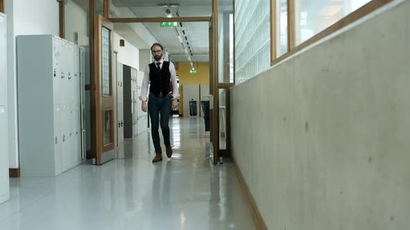 Male executive walking in corridor 