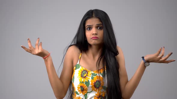 Confused Indian girl gesturing what