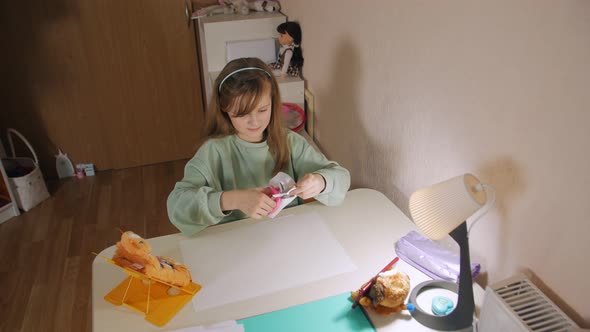 Girl Makes Paper Crafts