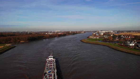 Aerial Flying Over Cargo Ship Across River Noord On Clear day. Dolly Forward