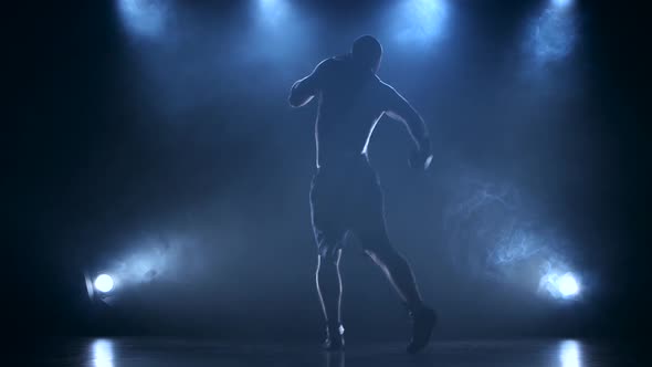 Coaching Boxer Male in a Dark Studio with Rear Lights