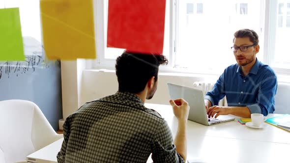 Business executives interacting with each other in conference room