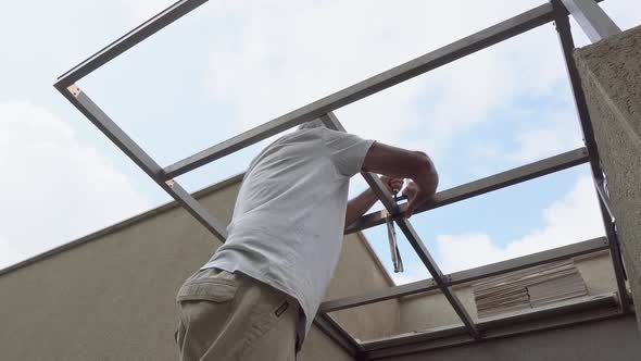 adult man constructing and building roof tightening work at home renovation