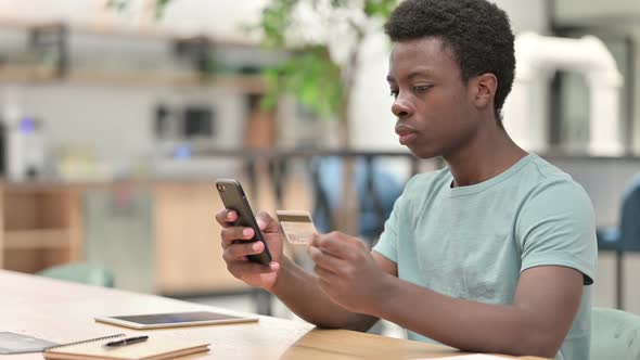 Online Shopping on Smartphone By African Man Online Payment