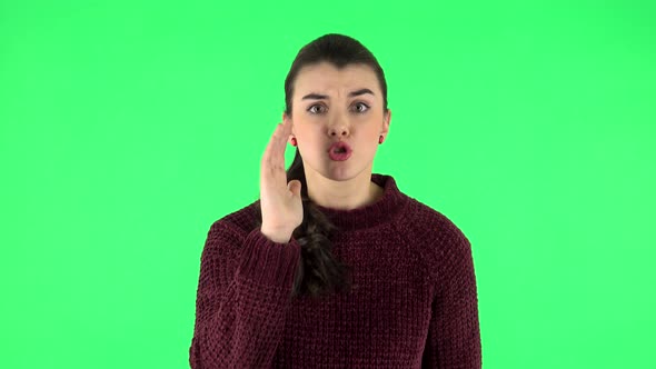 Annoyed Girl Screams Calling Someone on a Green Screen at Studio. Green Screen