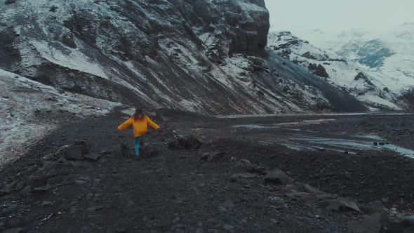 Woman walking in big snowy valley