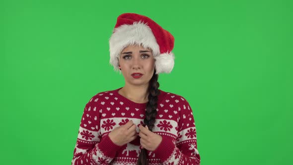 Portrait of Sweety Girl in Santa Claus Hat Is Standing Worrying in Expectation Then Smiles with