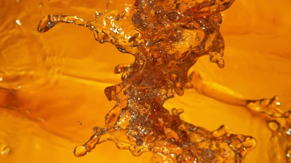 Super Slow Motion Shot of Splashing Golden Liquid at 1000 Fps.