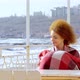 Beautiful Pensive Redhead Woman Sitting at the Beach Watching the Sea - VideoHive Item for Sale
