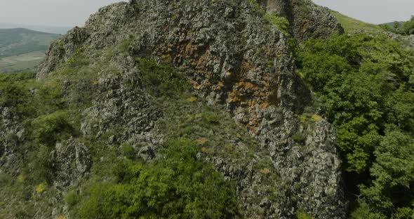 Panorama of the Azeula Fortress ruins located on a natural volcanic hill.